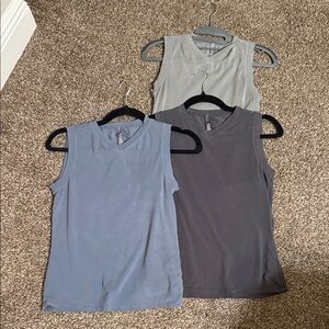 SKIMS Muscle Tees in Gray, Blue, and Charcoal